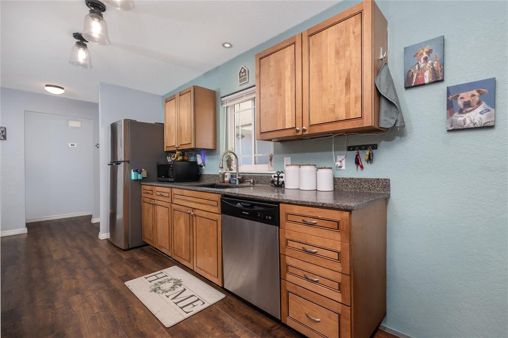 1709 Umbrella Tree Drive Edgewater, FL 32132 - Photo 7 of 37 a kitchen with stainless steel appliances granite countertop a refrigerator a stove top oven a sink and dishwasher