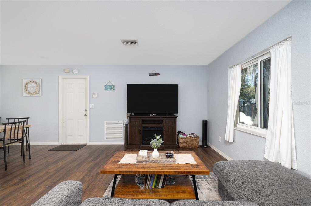 1709 Umbrella Tree Drive Edgewater, FL 32132 - Photo 9 of 37 a living room with furniture and a flat screen tv