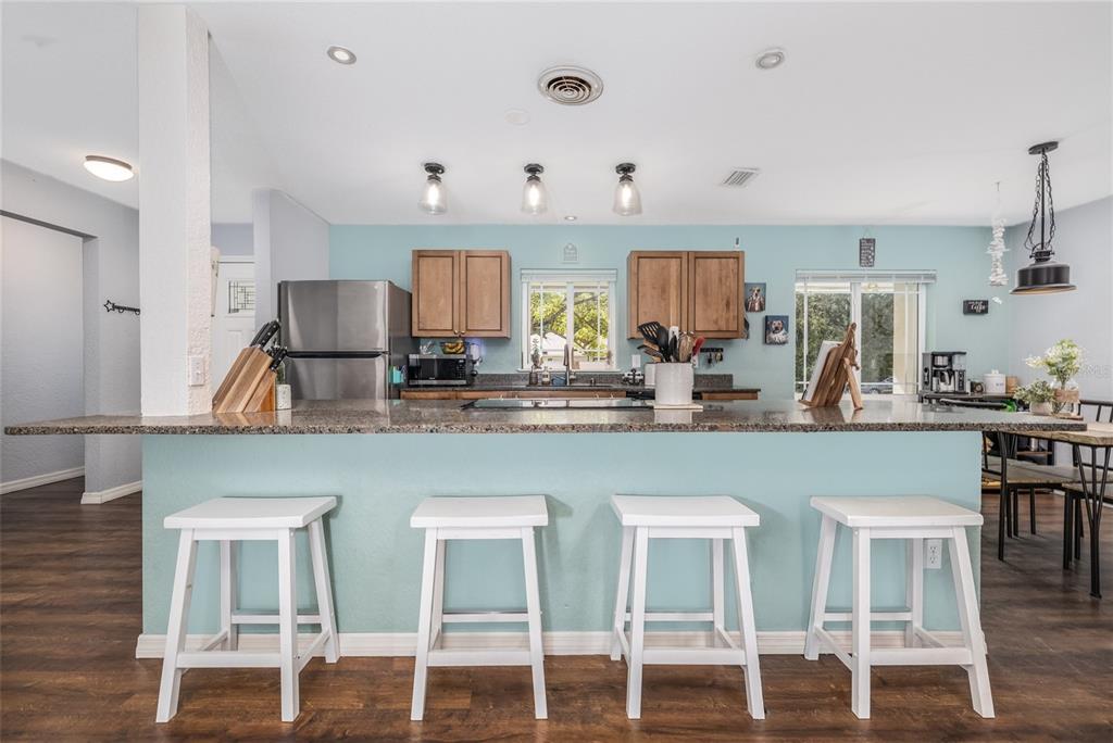 1709 Umbrella Tree Drive Edgewater, FL 32132 - Photo 10 of 37 a kitchen with white cabinets and chairs