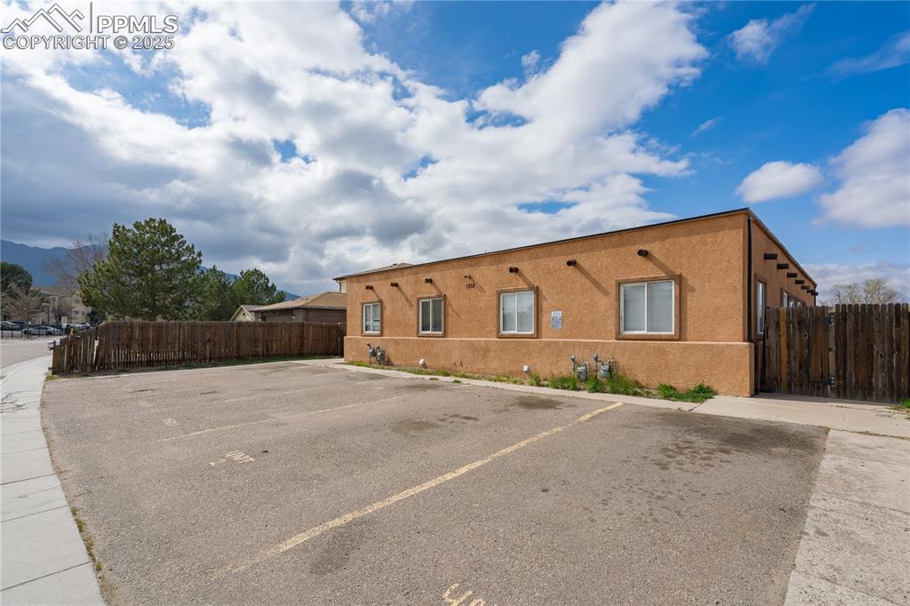 1712 Hampton South Colorado Springs, CO 80906 - Photo 20 of 22 Uncovered parking lot featuring fence