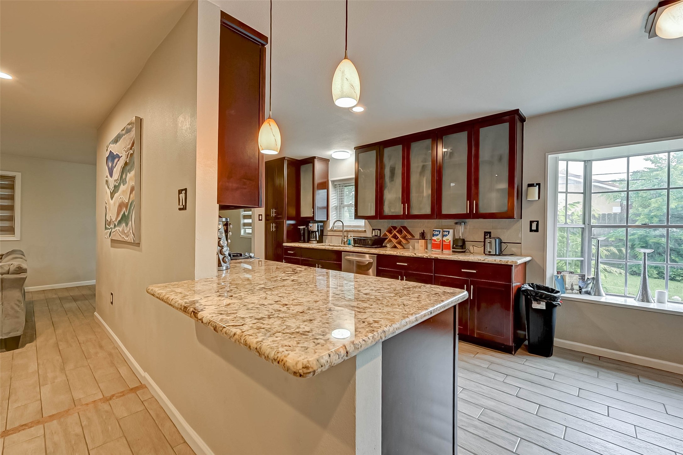 6119 Reamer Street Houston, TX 77074 - Photo 15 of 33 a kitchen with stainless steel appliances granite countertop a sink dishwasher stove and refrigerator with wooden floor