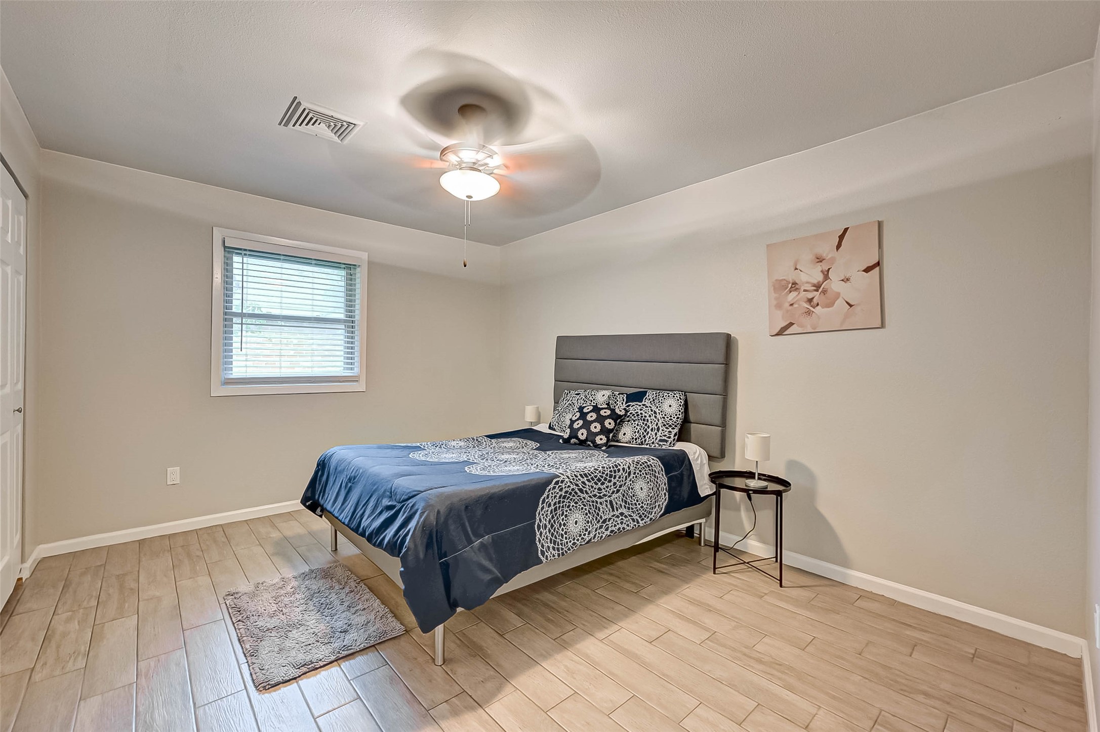 6119 Reamer Street Houston, TX 77074 - Photo 20 of 33 a bedroom with a bed and a chandelier
