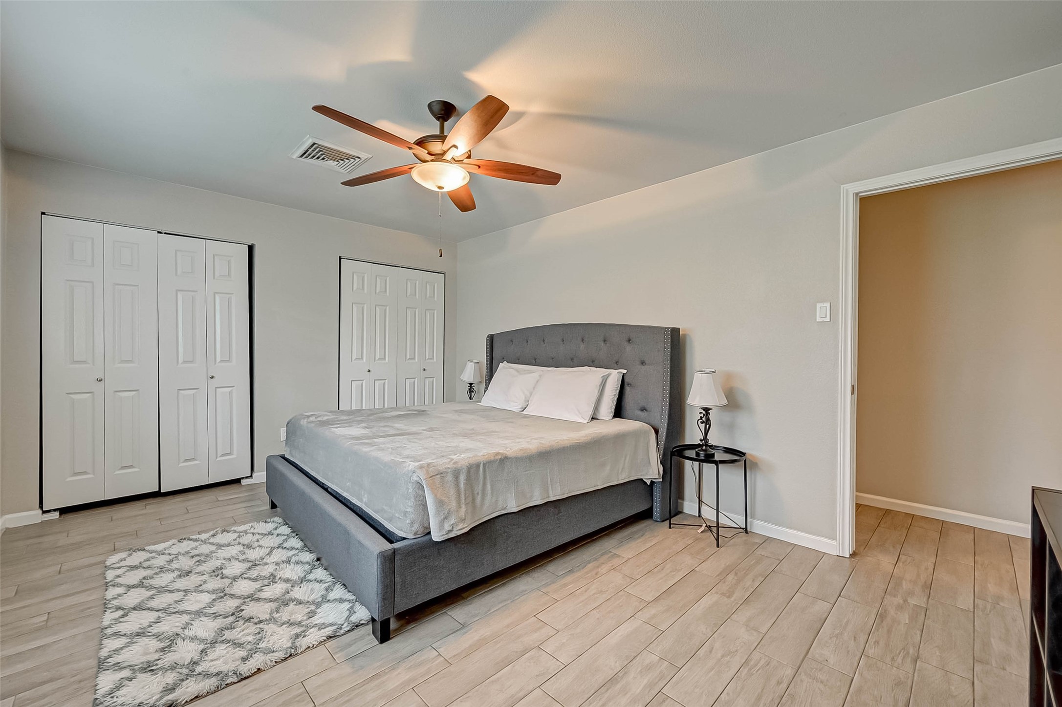 6119 Reamer Street Houston, TX 77074 - Photo 25 of 33 a bedroom with a bed and wooden floor