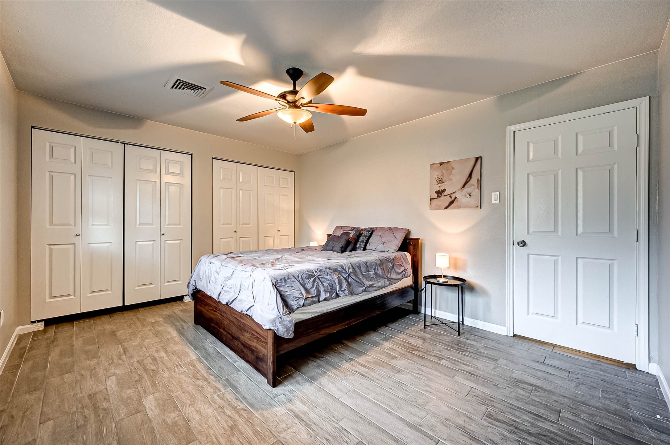 6119 Reamer Street Houston, TX 77074 - Photo 28 of 33 a spacious bedroom with a bed and a chandelier