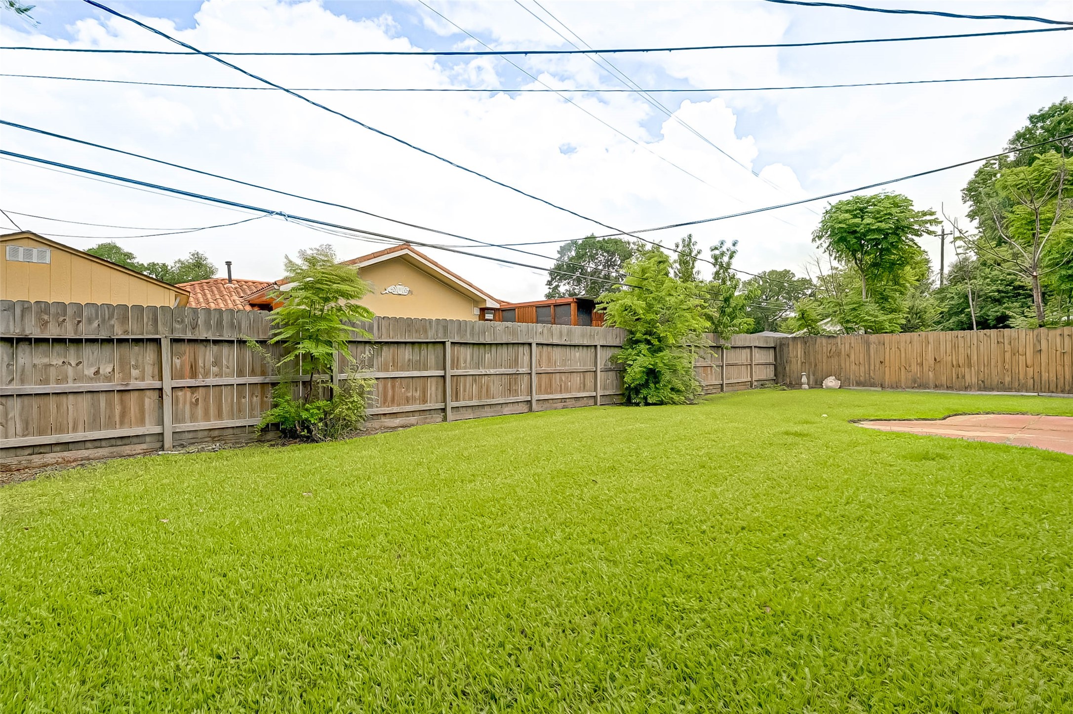 6119 Reamer Street Houston, TX 77074 - Photo 33 of 33 a view of a backyard with plants and wooden fence