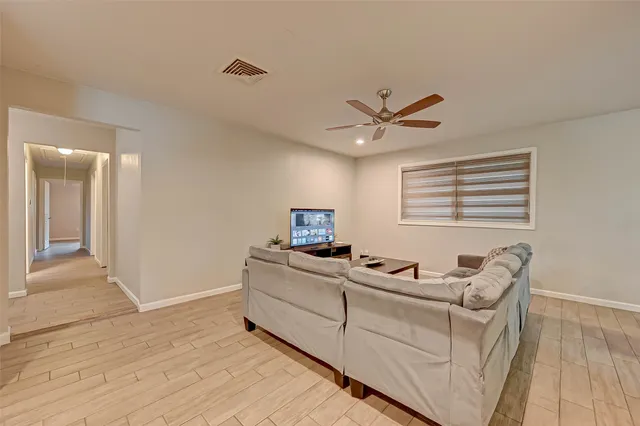 a living room with furniture and two windows