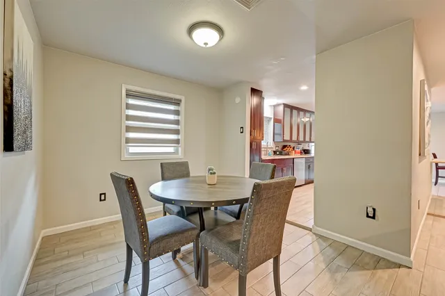 a view of a dining room with furniture and window