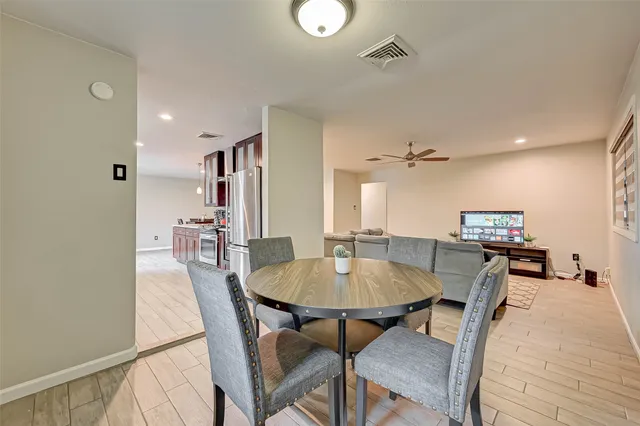 a dining room with furniture and window