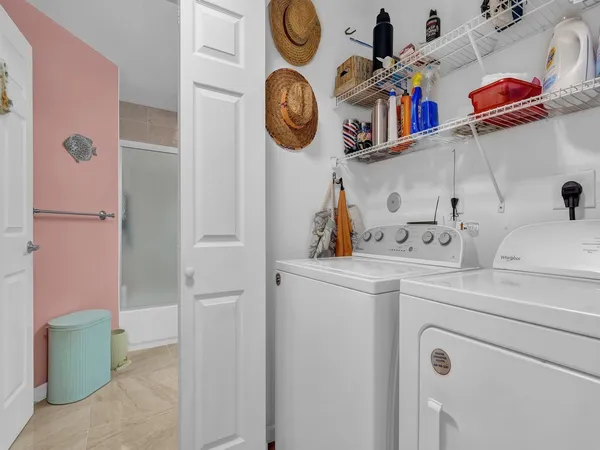 a view of storage and utility room with washer and dryer