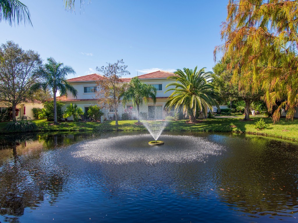 528 7th Square Southwest, Unit 102 Vero Beach, FL 32962 - Photo 19 of 28 a view of a lake with a house in the background