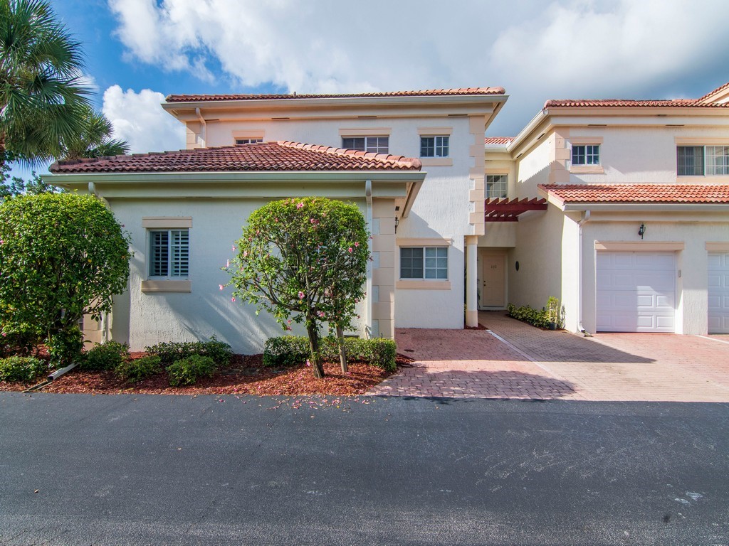 528 7th Square Southwest, Unit 102 Vero Beach, FL 32962 - Photo 3 of 28 a front view of a house with a garage and a yard