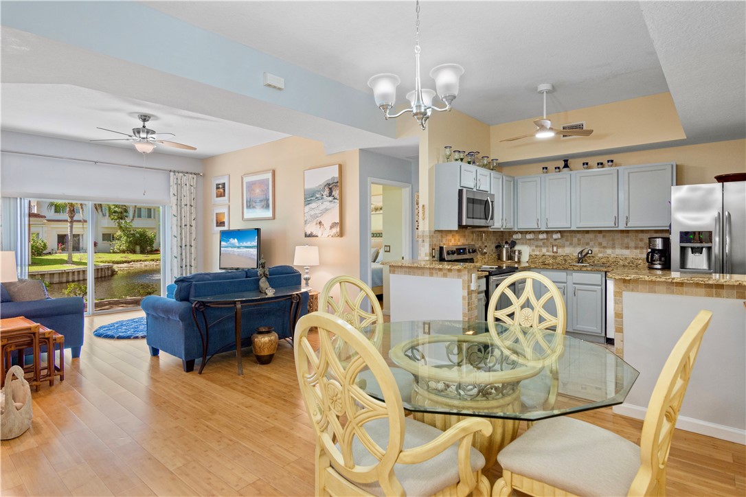 528 7th Square Southwest, Unit 102 Vero Beach, FL 32962 - Photo 4 of 28 a living room with furniture kitchen view and a chandelier