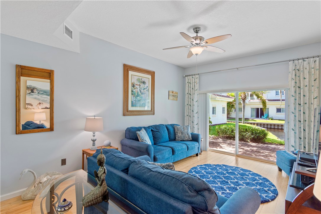 528 7th Square Southwest, Unit 102 Vero Beach, FL 32962 - Photo 7 of 28 a living room with furniture and a large window