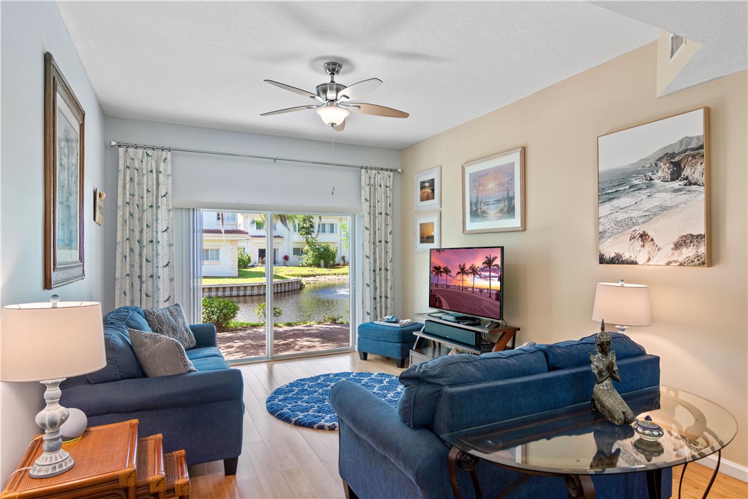 528 7th Square Southwest, Unit 102 Vero Beach, FL 32962 - Photo 8 of 28 a living room with furniture and a large window