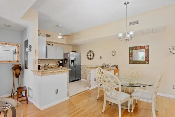 a view of a dining room with furniture and a chandelier