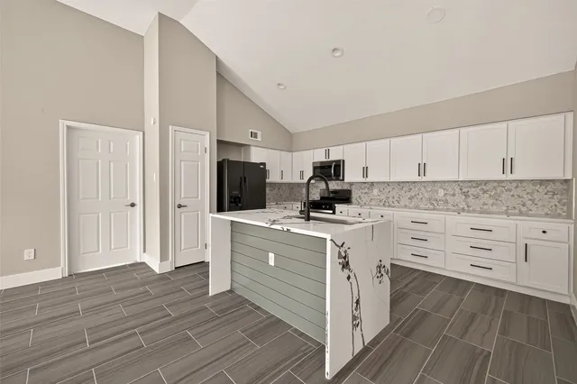 a kitchen with white cabinets stainless steel appliances and sink