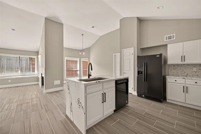 a kitchen with a refrigerator stove and wooden cabinets