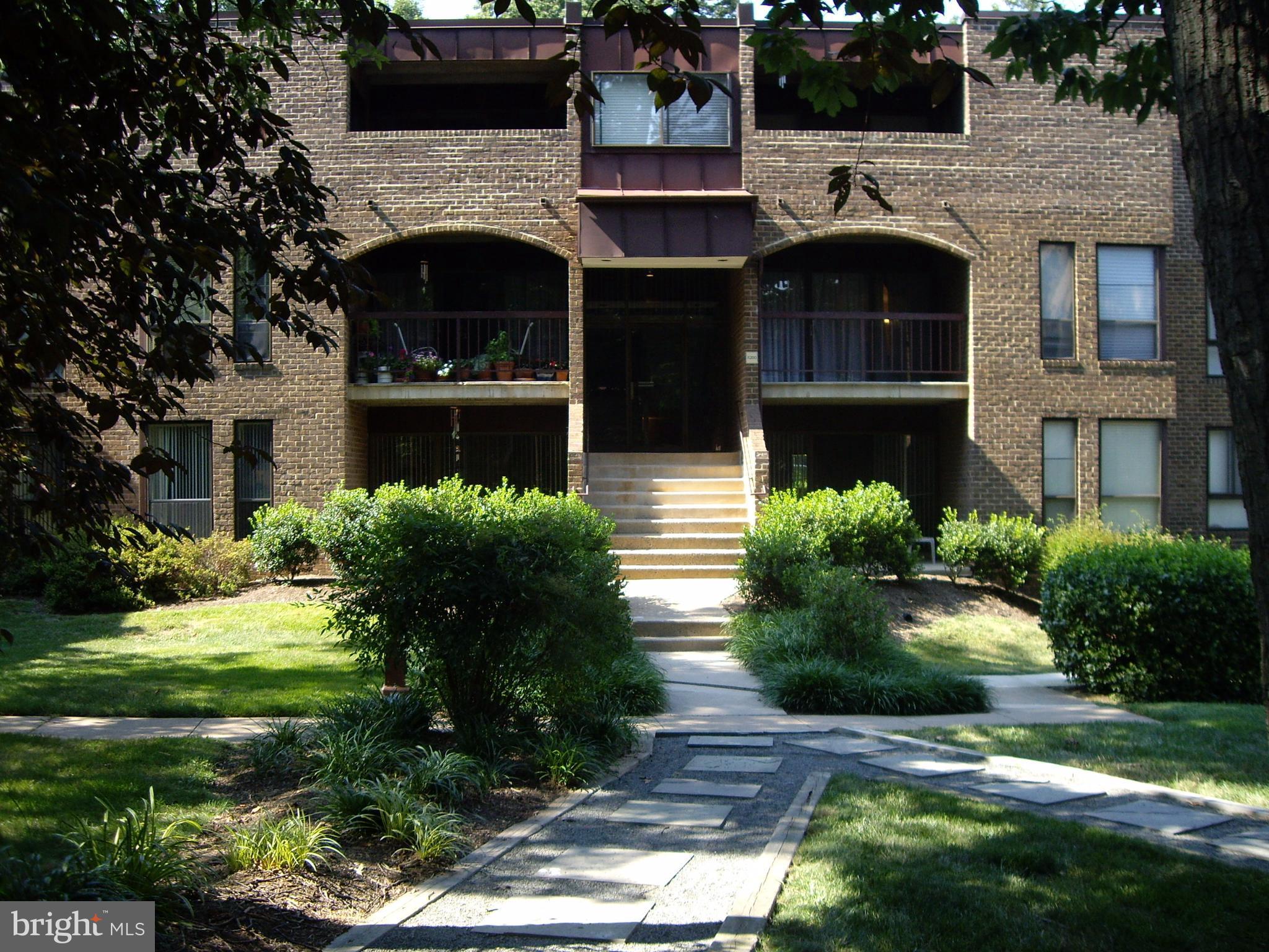 11200 Chestnut Grove Square, Unit 303 Reston, VA 20190 - Photo 25 of 30 a front view of a house with garden