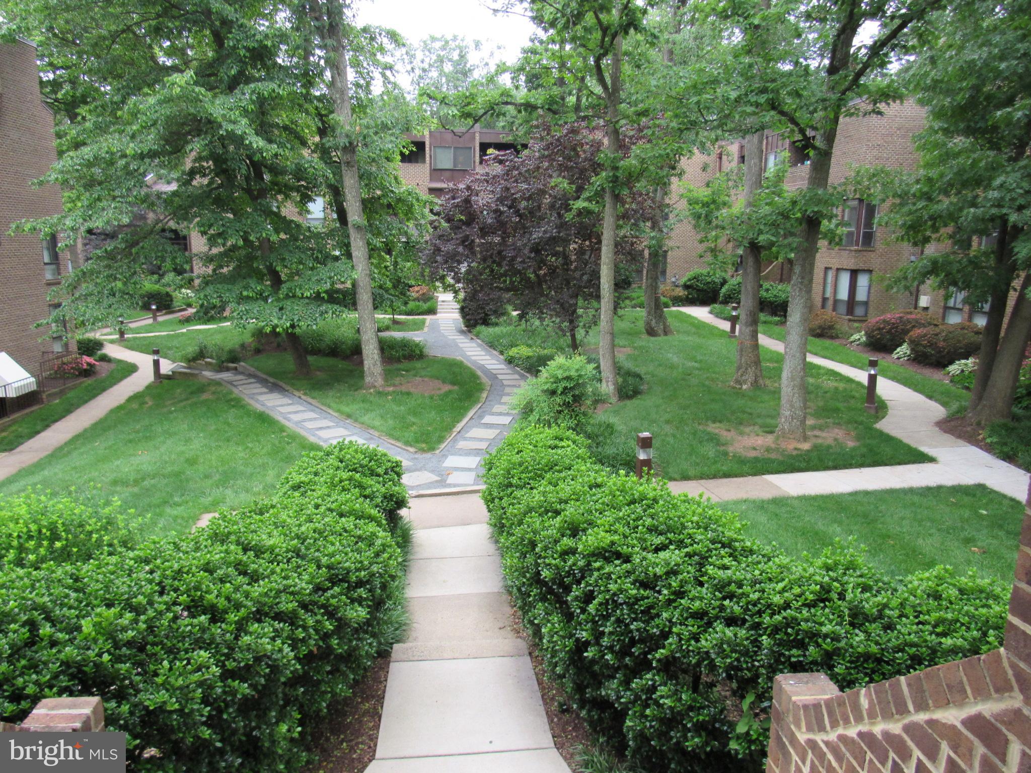 11200 Chestnut Grove Square, Unit 303 Reston, VA 20190 - Photo 26 of 30 a view of a garden with patio