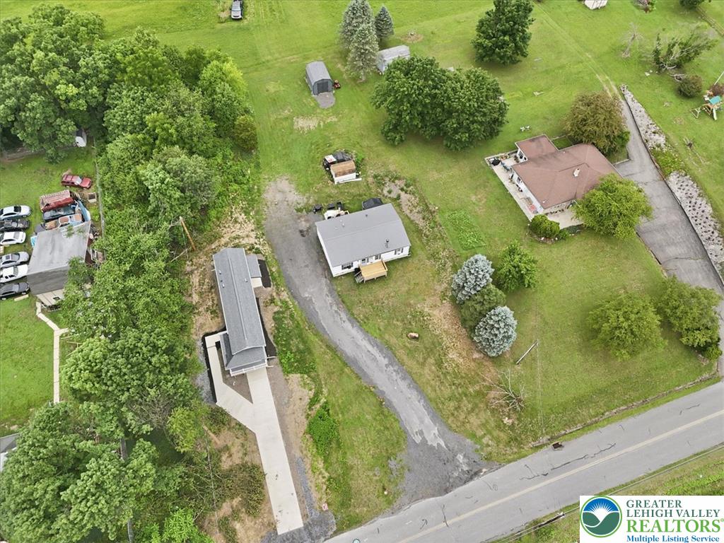 634 Main Road Lehighton, PA 18235 - Photo 5 of 39 An aerial perspective reveals the expansive land surrounding multiple homes, highlighting the blend of residential and natural landscapes.
