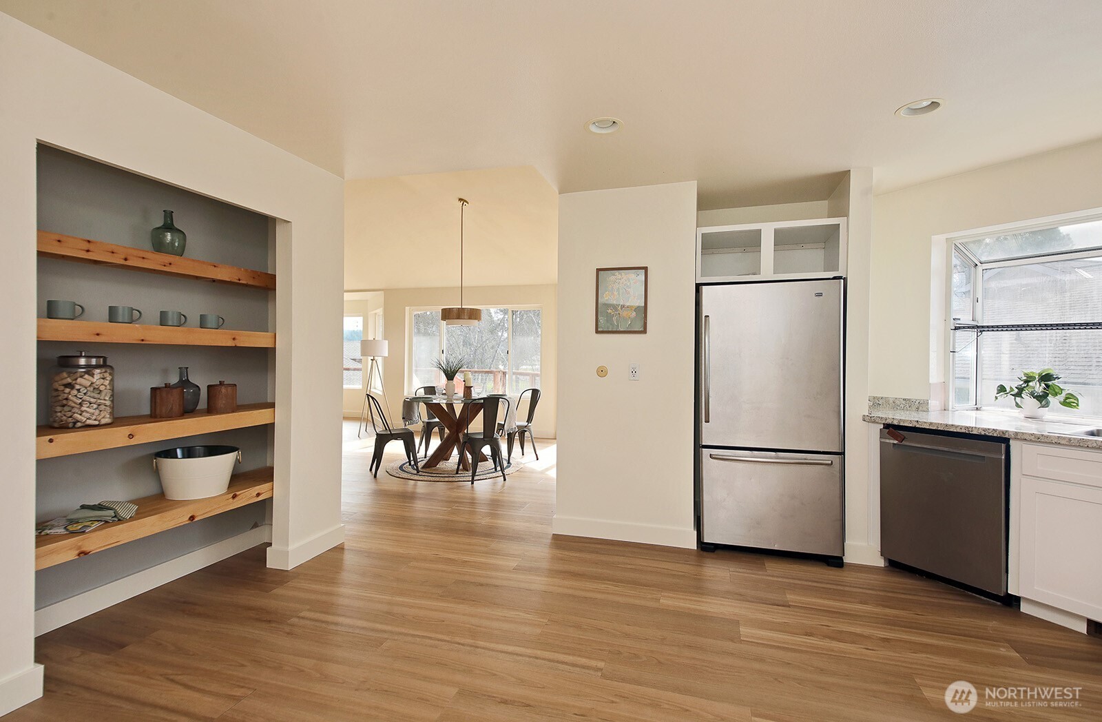 5663 Lenz Place Langley, WA 98260 - Photo 11 of 37 a kitchen with granite countertop a refrigerator and wooden floor
