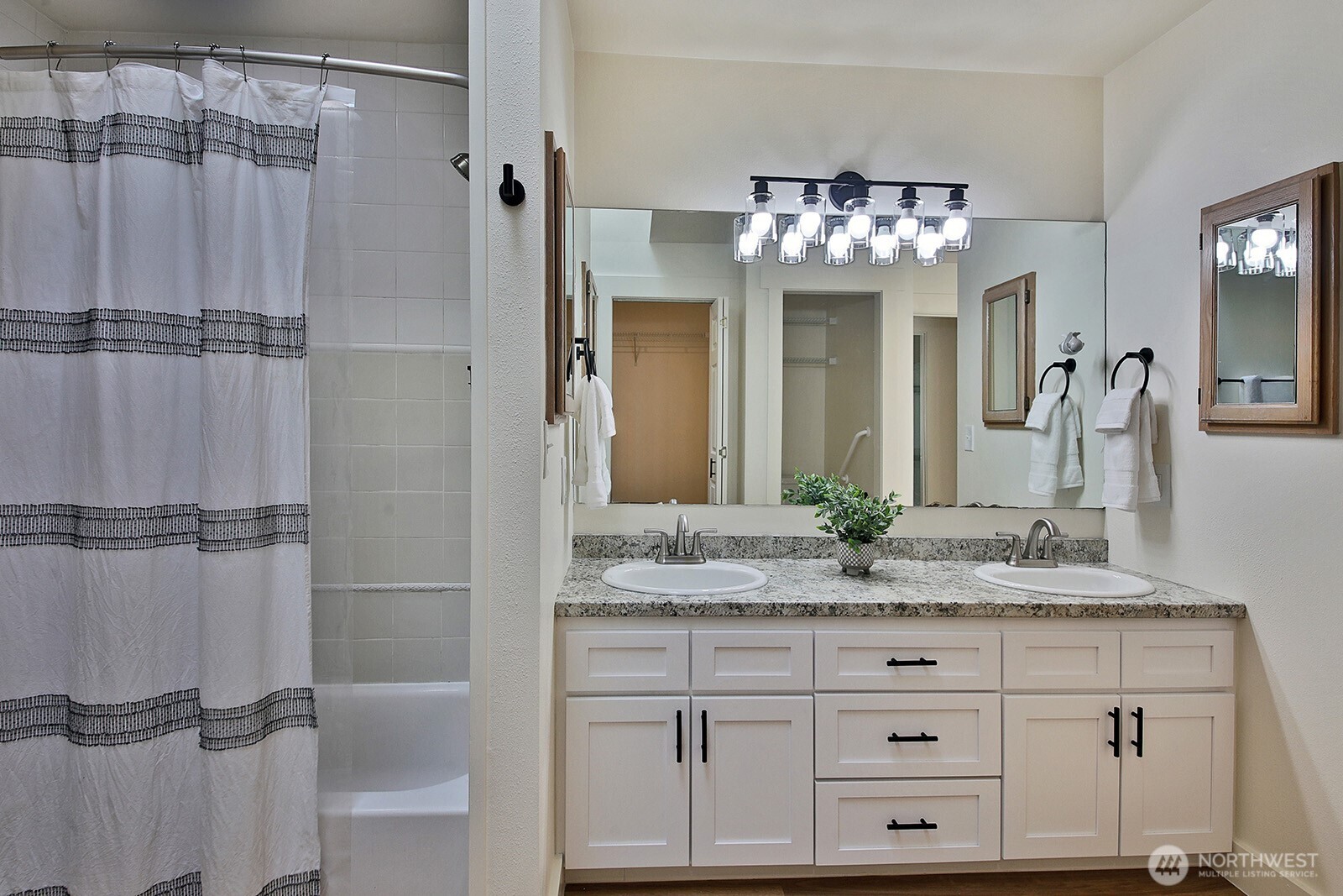 5663 Lenz Place Langley, WA 98260 - Photo 16 of 37 a bathroom with a granite countertop shower sink and mirror
