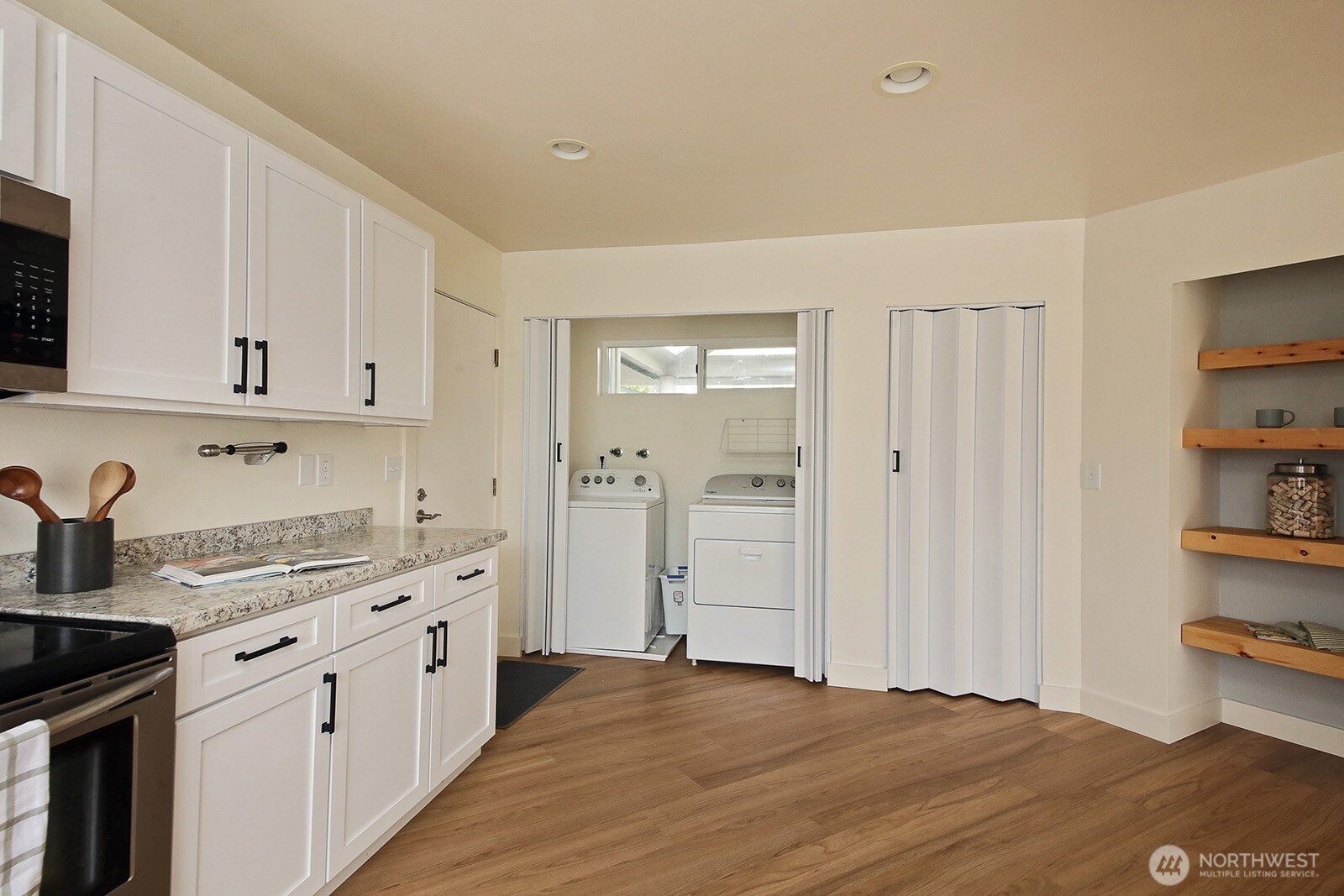 5663 Lenz Place Langley, WA 98260 - Photo 9 of 37 a kitchen with white cabinets and sink