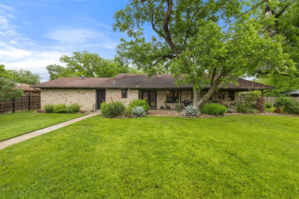 302 South Schramm Road Granger, TX 76530 - Photo 25 of 33 a front view of a house with a garden