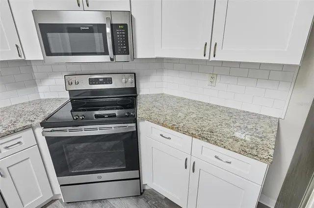 a kitchen with appliances cabinets and a counter top space
