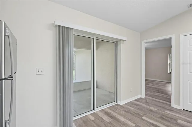 an empty room with a bathroom and a window