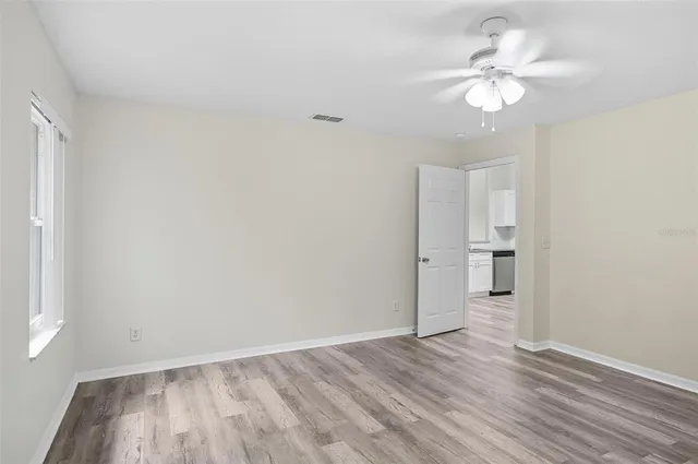 a view of a small space with wooden floor and a window