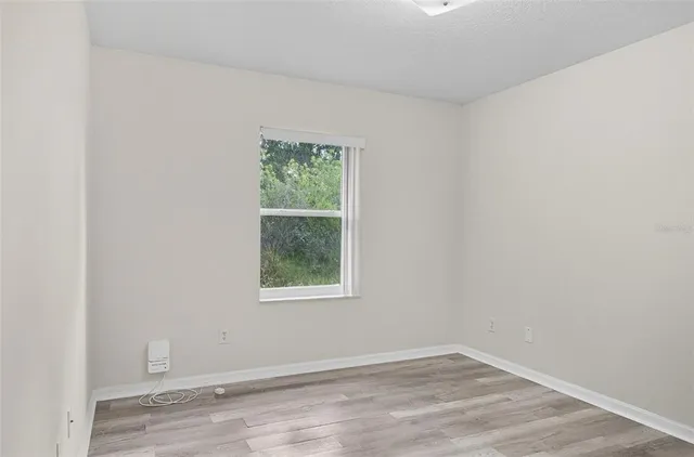 an empty room with wooden floor