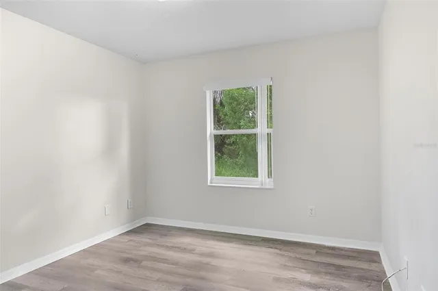 an empty room with wooden floor