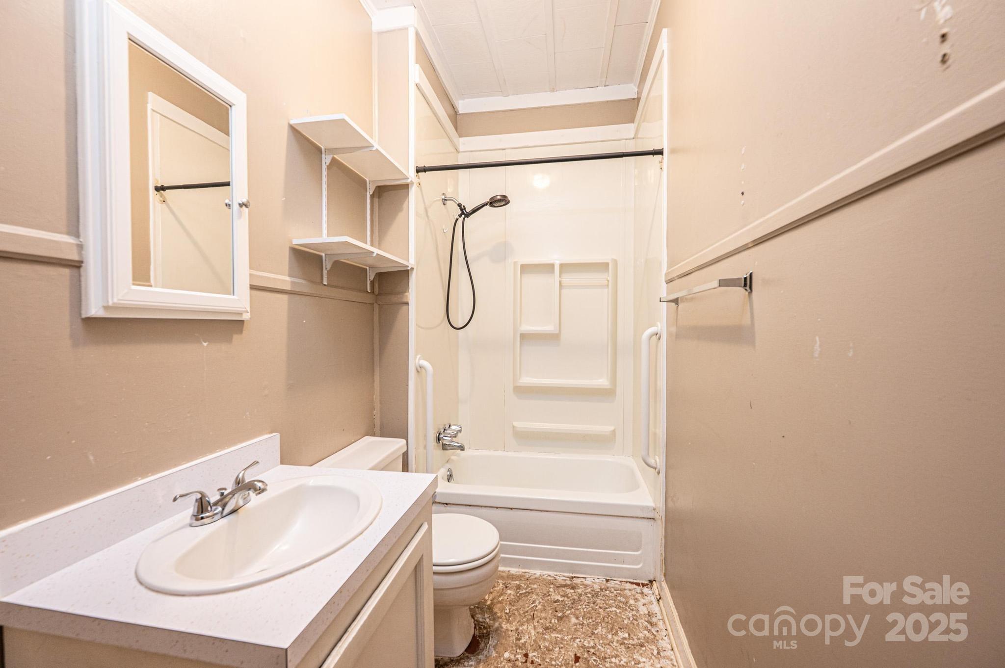 4823 Calico Road Lenoir, NC 28645 - Photo 15 of 31 a bathroom with a sink toilet and shower