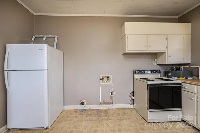 a view of a kitchen with sink and cabinets