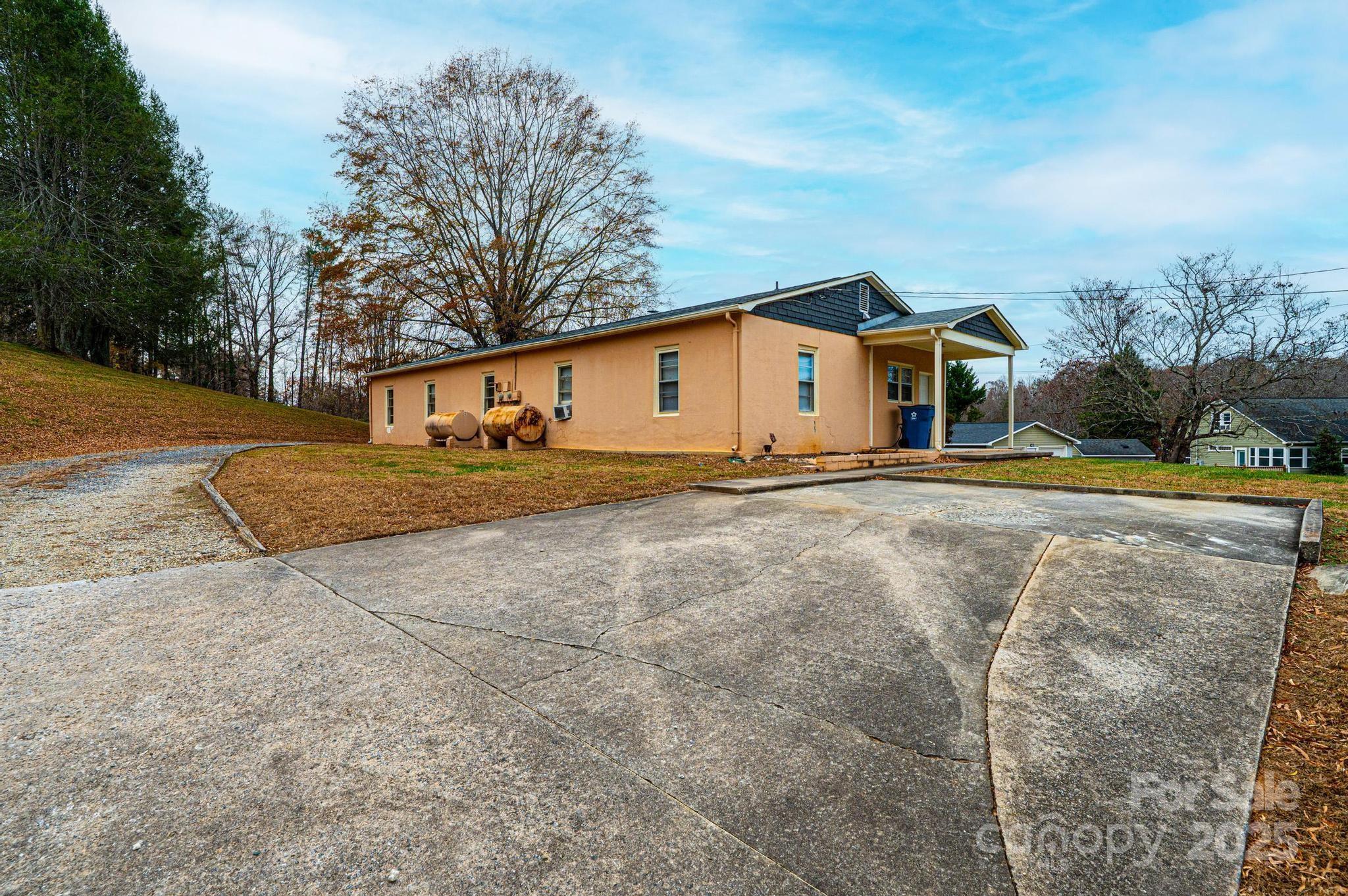 4823 Calico Road Lenoir, NC 28645 - Photo 2 of 31 a front view of a house with a yard and garage