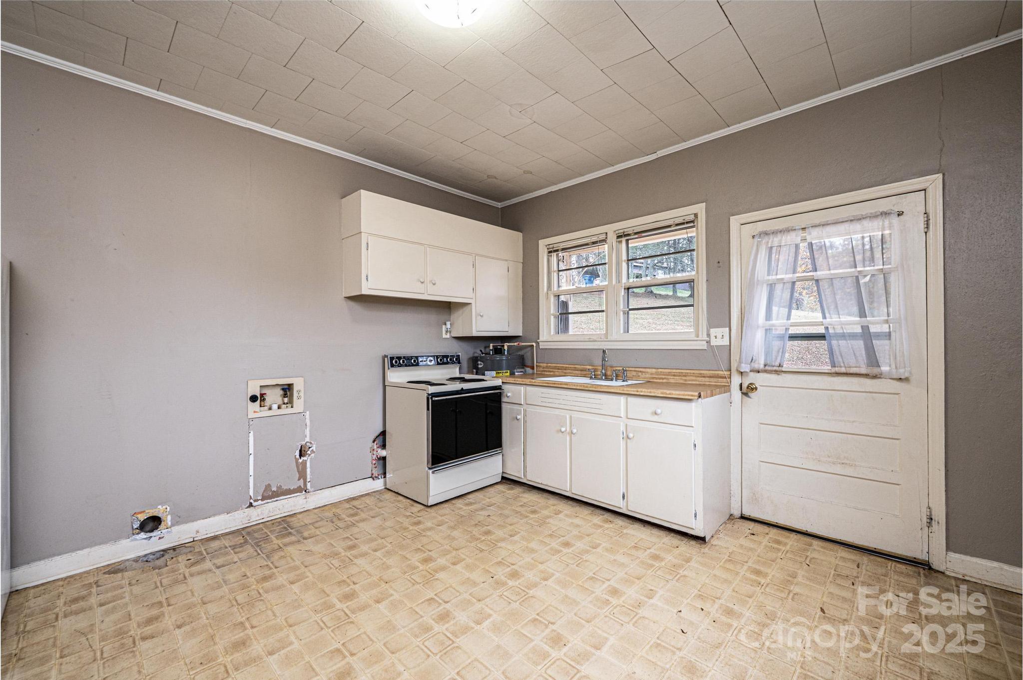 4823 Calico Road Lenoir, NC 28645 - Photo 24 of 31 a kitchen with granite countertop white cabinets and white appliances