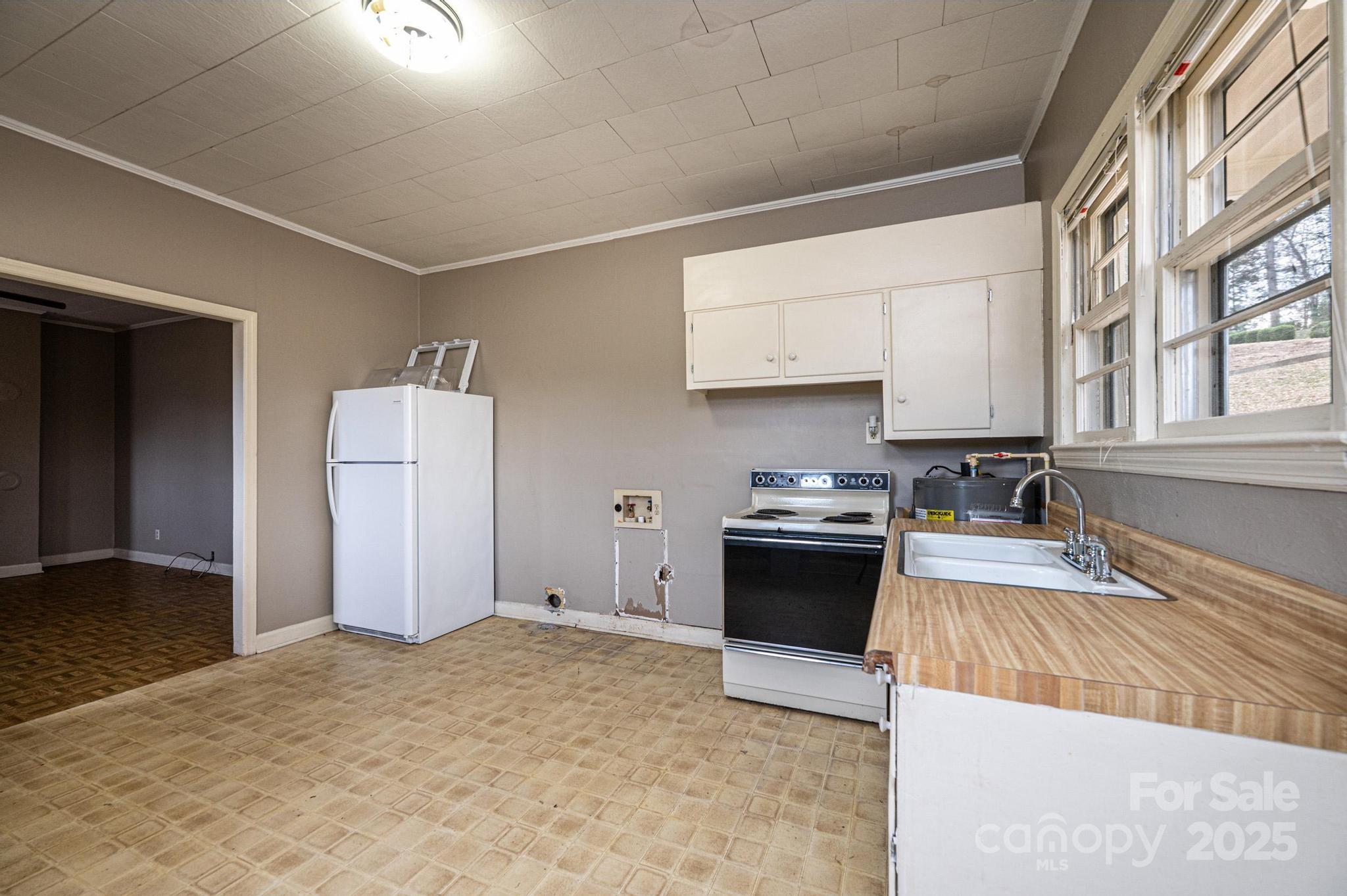 4823 Calico Road Lenoir, NC 28645 - Photo 25 of 31 a kitchen with a cabinets and white appliances