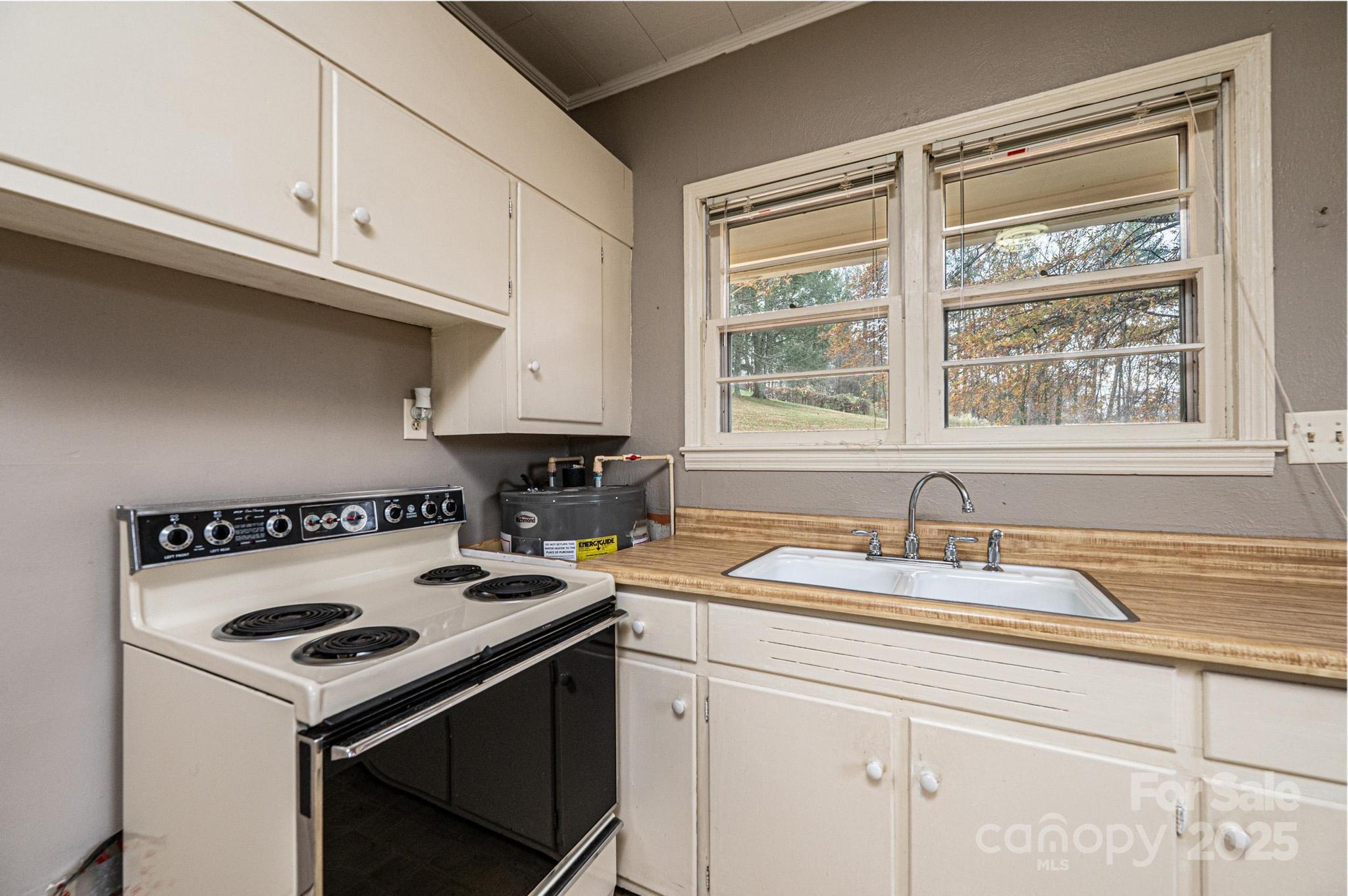 4823 Calico Road Lenoir, NC 28645 - Photo 27 of 31 a kitchen with a stove and a sink