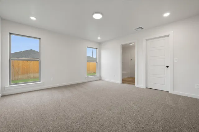 an empty room with windows and closet