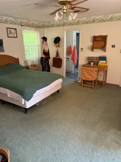 a bedroom with furniture and a flat screen tv