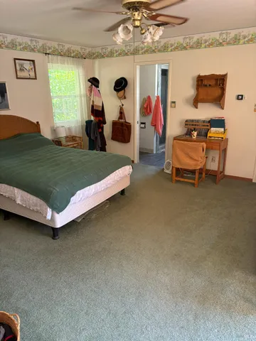 a bedroom with furniture and a flat screen tv