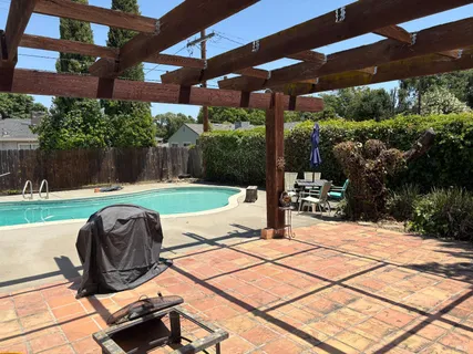 a view of a house with swimming pool and porch