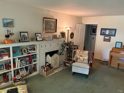 a bedroom with furniture and a book shelf