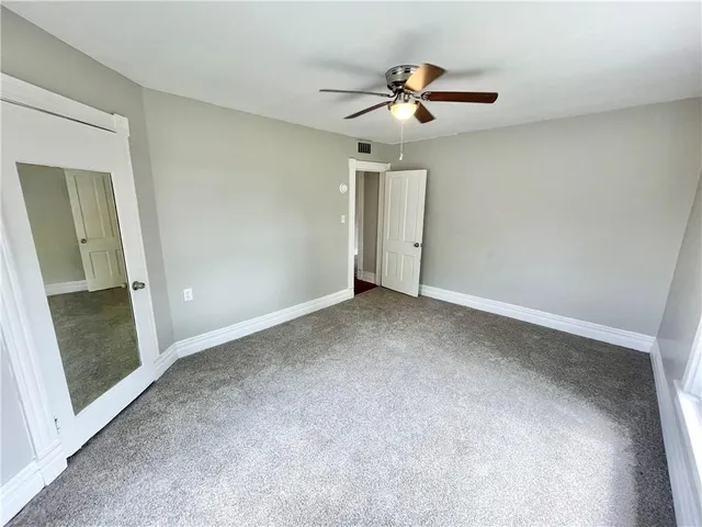 an empty room with a mirror