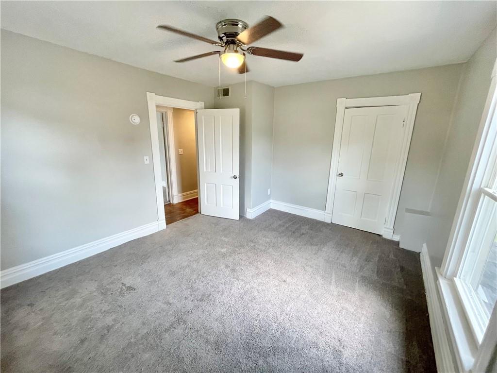 811 Carlisle Street, Unit 2 New Castle, PA 16101 - Photo 20 of 23 a view of a big room with chandelier fan and windows