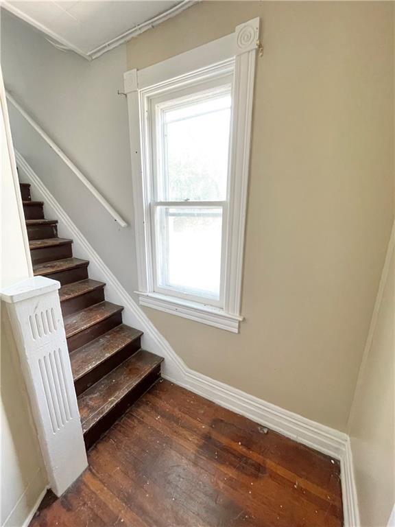 811 Carlisle Street, Unit 2 New Castle, PA 16101 - Photo 2 of 23 a view of an empty room with wooden floor and stairs