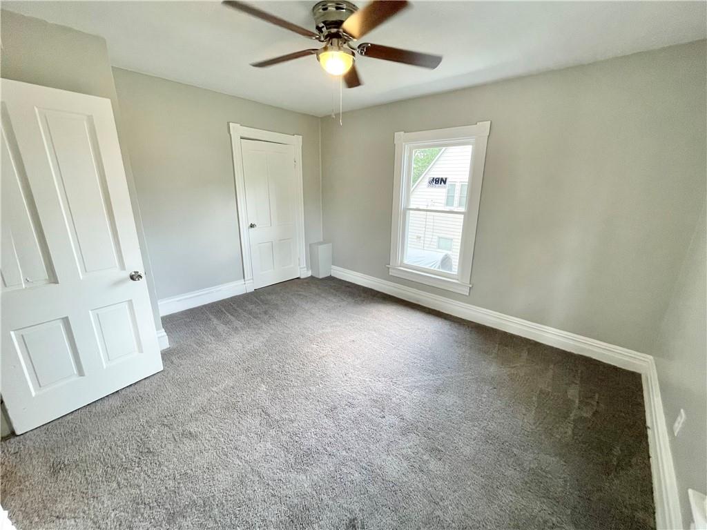 811 Carlisle Street, Unit 2 New Castle, PA 16101 - Photo 21 of 23 an empty room with windows and fan