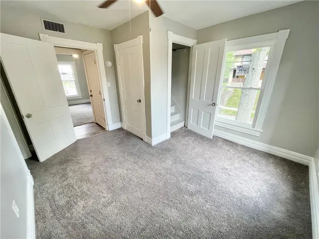 an empty room with windows and entrance