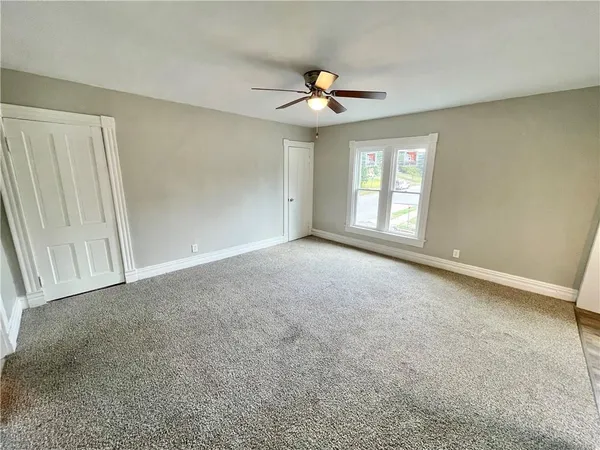 a view of an empty room with a window